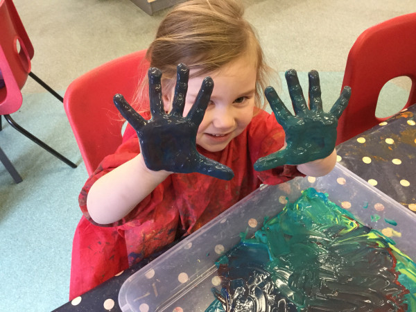 A child painted her hands at Alton College Nursery in Alton, Guildford