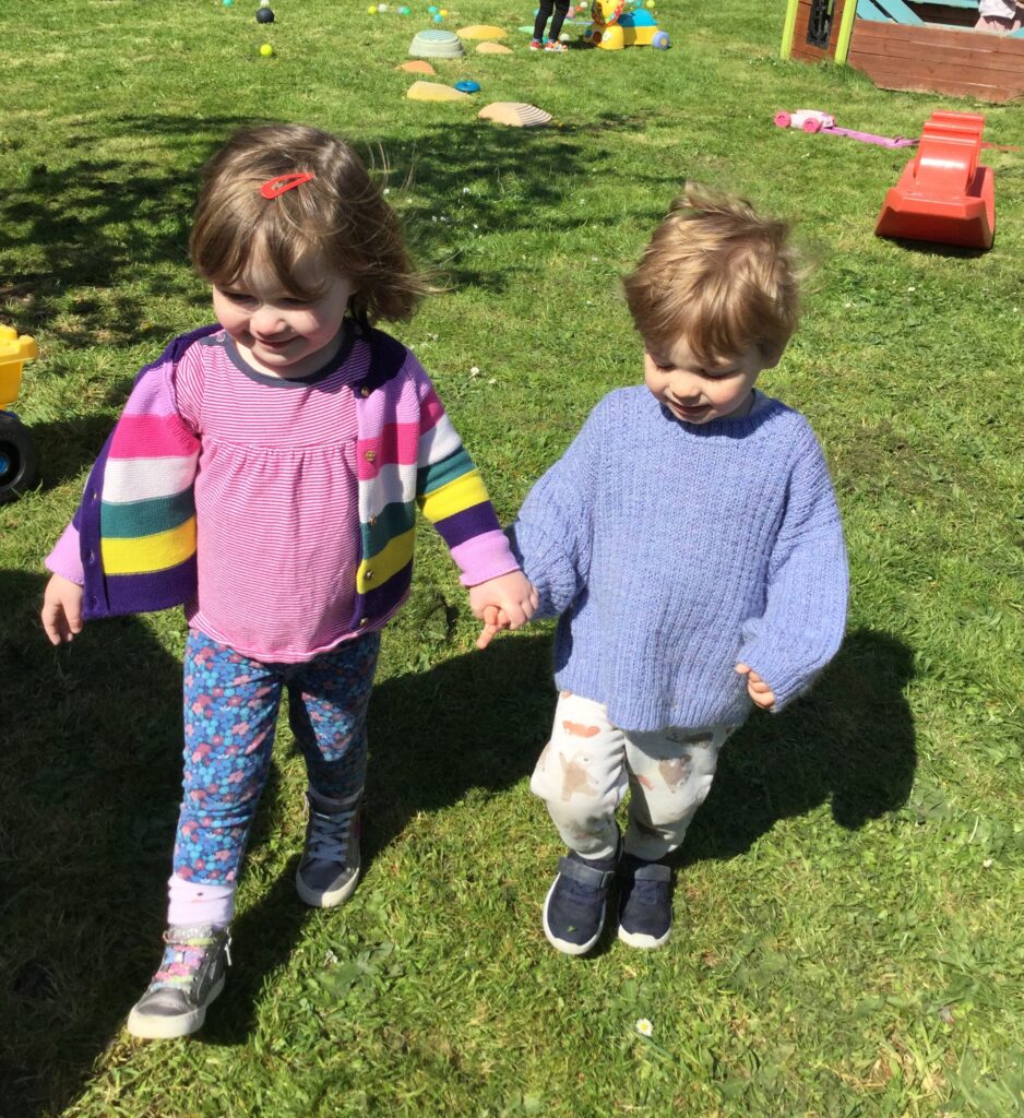 Children holding hands and walking together at Alton College Nursery